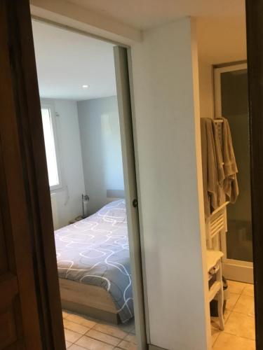 a door leading into a bedroom with a bed at La Varenne in Changy