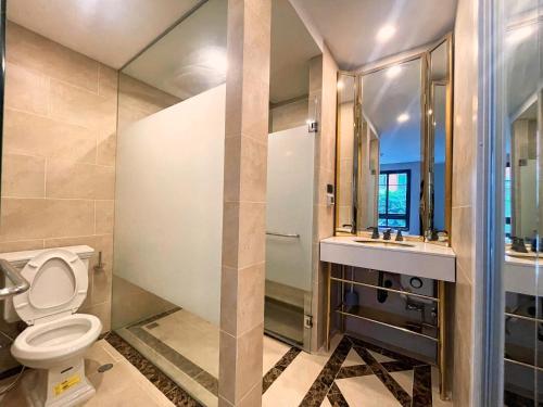 a bathroom with a toilet and a sink at Espana Vacation Residence Jomtien & Yahaha in Pattaya South