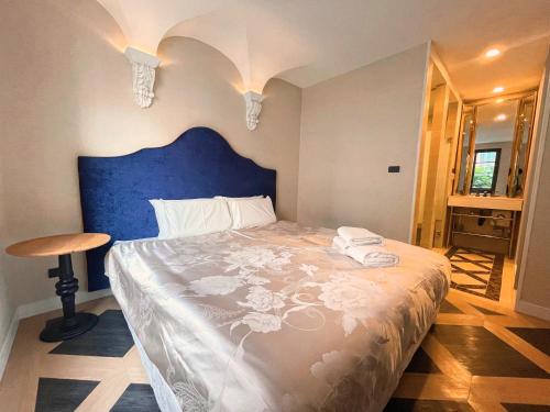 a bedroom with a large bed with a blue headboard at Espana Vacation Residence Jomtien & Yahaha in Pattaya South