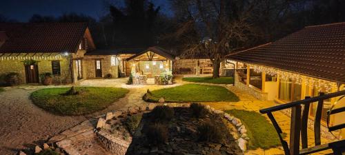 a home with a yard with a stone patio at Chateau Orman in Orman