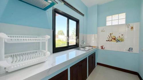 a large kitchen with a sink and a window at Happy Home Villa 1 in Nathon Bay