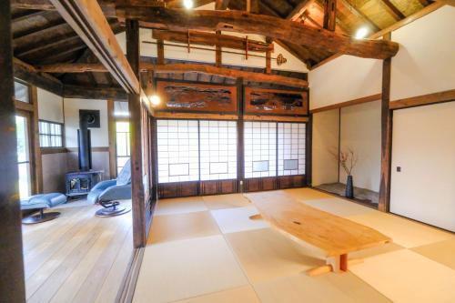 una sala de estar con una mesa de madera en el centro en しまなみ宿Gyoku, en Imabari