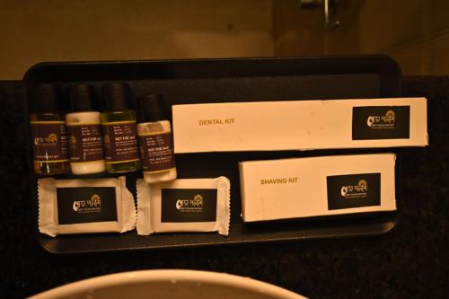 a black counter with several bottles of soap and boxes at Swet Palash Resort in Purulia