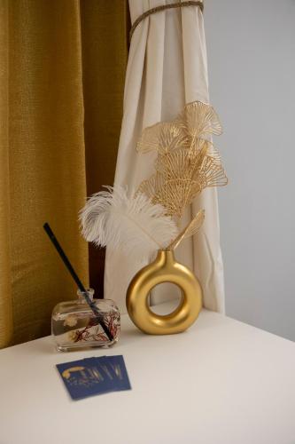 a table with a gold pair of scissors and a candle at Enchanting Suites Salerno in Salerno