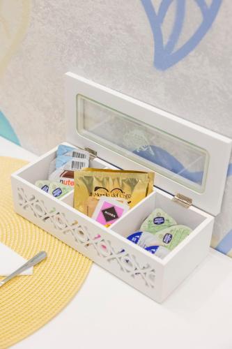 a white box filled with different items on a table at Enchanting Suites Salerno in Salerno