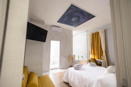 - une chambre avec un lit blanc et un plafond étoilé dans l'établissement Enchanting Suites Salerno, à Salerne