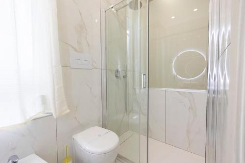 a bathroom with a shower and a toilet at Enchanting Suites Salerno in Salerno