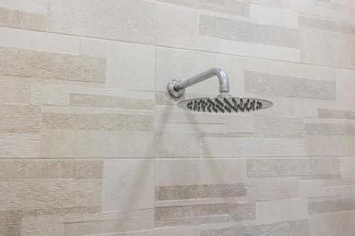 a shower with a shower head with water coming out at Enchanting Suites Salerno in Salerno
