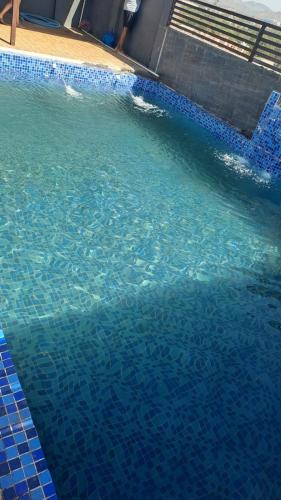 a large swimming pool with blue water in it at Hotel Dosa plaza in Udaipur