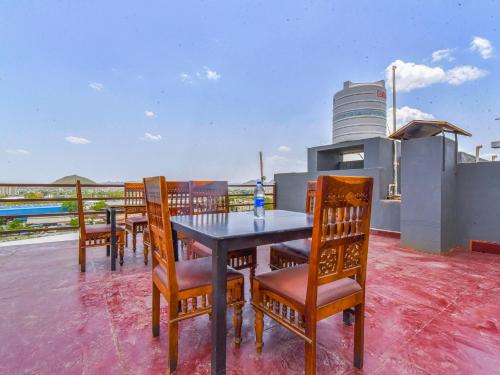 a table and chairs on the roof of a house at Hotel Dosa plaza in Udaipur