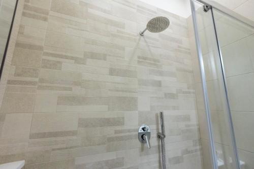 a bathroom with a shower with a glass door at Enchanting Suites Salerno in Salerno