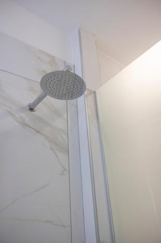 a shower with a shower head in a room at Enchanting Suites Salerno in Salerno