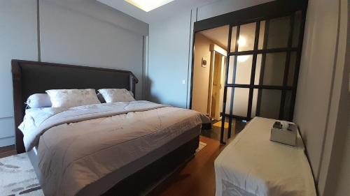 a bedroom with a large bed and a window at Ruby Apartment #23 in Yogyakarta