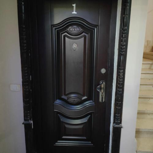 a black door with a mirror on it at Hurghada City Apartment1 in Hurghada