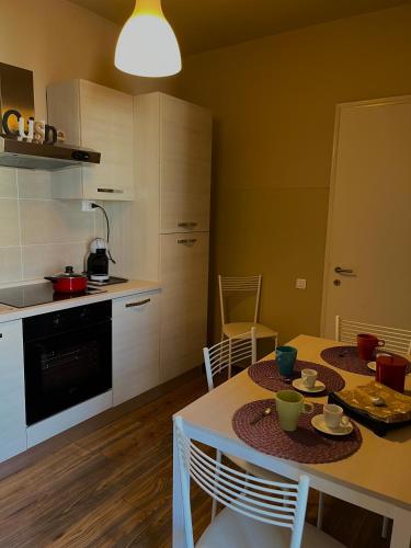 a kitchen with a table with chairs and a dining room at Sweet Home in Pisa