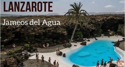 a group of people standing around a swimming pool at a resort at Apartamento Lory-Puerto del Carmen in Puerto del Carmen