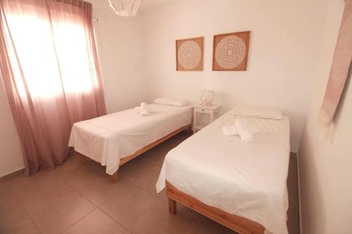A bed or beds in a room at Beach - Sun apartament - Sol y Playa Puerto del Carmen