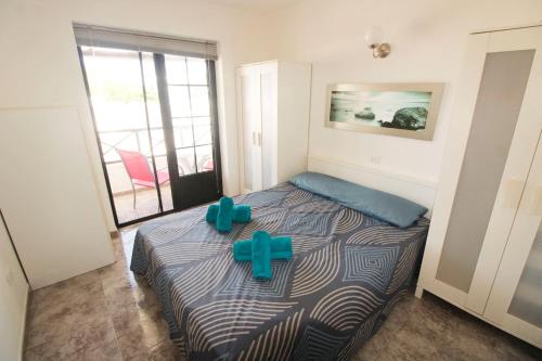 a bedroom with a bed with a cross on it at Dúplex Vista Mar Puerto Del Carmen in Puerto del Carmen