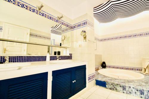 a bathroom with blue doors and a tub at Luxury Villa Alfred in Puerto del Carmen