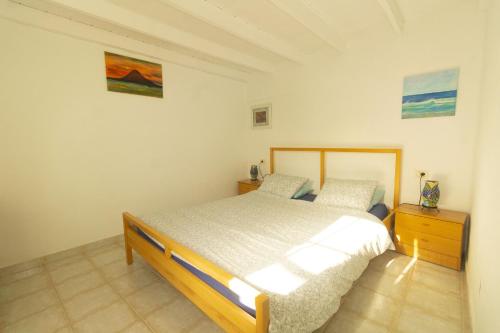 a bedroom with a bed and a dresser in it at Luxury Villa Alfred in Puerto del Carmen