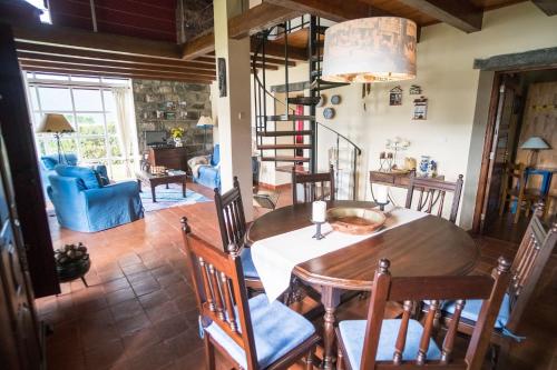 a dining room with a table and chairs at Casa da Lagoa in Sete Cidades