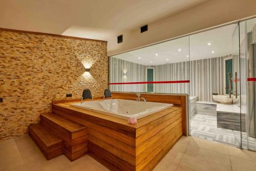 a large bathroom with a tub and a shower at Park Dedeman Kastamonu in Kastamonu