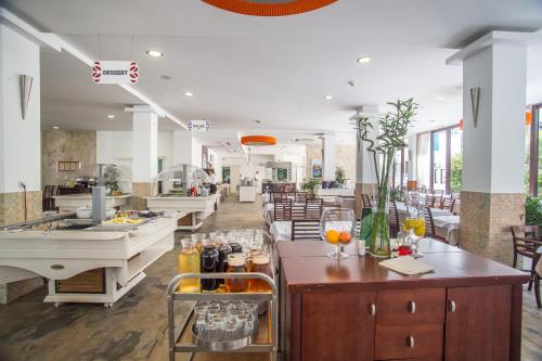 a restaurant with tables and chairs in a room at Hotel Aleksandar in Budva
