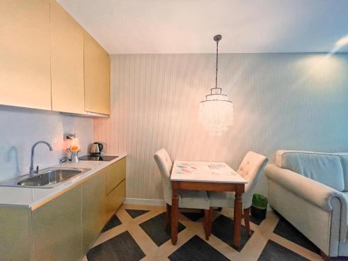 a small kitchen with a table and a sink at Espana Vacation Residence Jomtien & Yahaha in Pattaya South