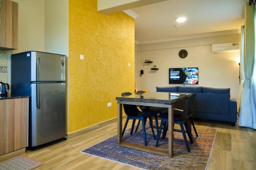 a kitchen and dining room with a table and a refrigerator at Westwood Residences in Arusha
