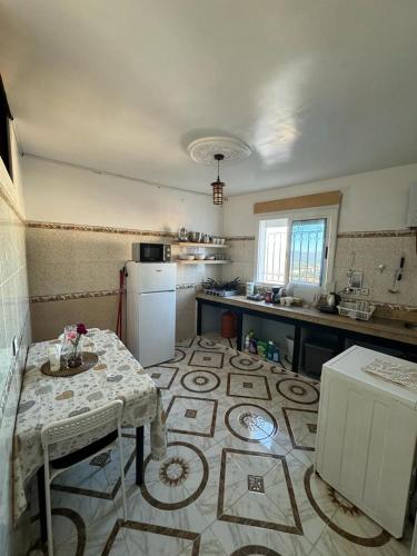 a kitchen with a table and a counter top at Dar Saphire in Chefchaouene