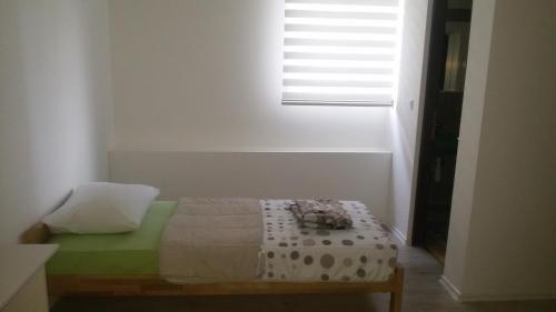 a bedroom with a bed and a window at Motel Maks in Kiseljak