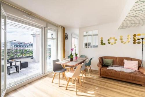 a living room with a couch and a table at Disney at home 3 bed rooms- Confort 90m2 - best location in Serris