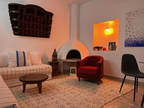 a living room with a couch and a fireplace at Stella Maris, Asilah medina in Asilah
