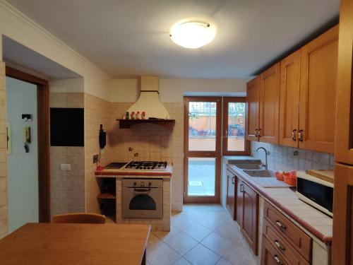 a kitchen with a sink and a stove top oven at Domus Laurenza in Acilia