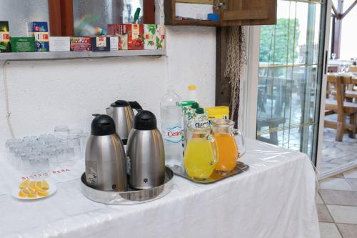 a white table with pitchers of orange juice on it at MB Pag Bed&Breakfast in Pag