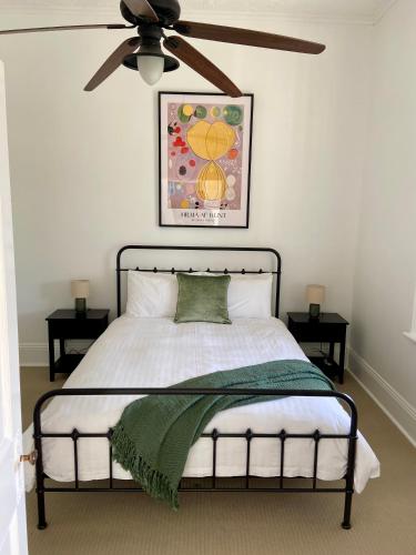 a bedroom with a bed with a ceiling fan at The Cottage at Seppeltsfield, Barossa Valley in Seppeltsfield