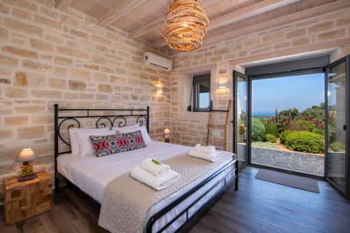 a bedroom with a bed with towels on it at Villa PanSara Exclusive Luxury in Metochia Fratzeskiana