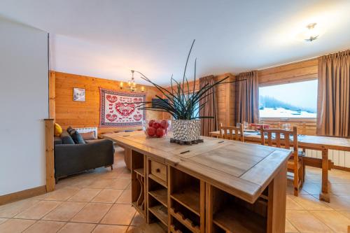 a living room with a wooden table and a couch at Residence Bec in Chamonix