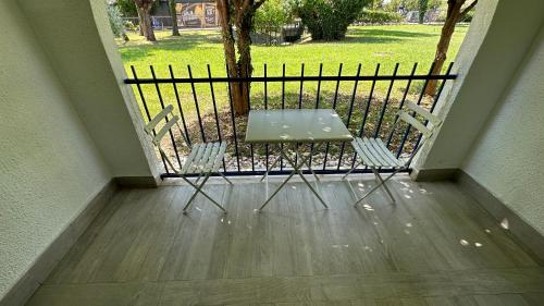 a table and chairs on a balcony with a fence at Hotel Aleksandar in Budva