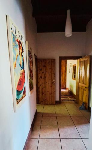 a hallway with posters on the walls of a house at Mountainview Vineyards in Robertson