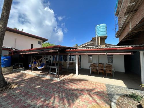 a patio of a house with a water tower on the roof at Kenno's Korner in Weligama