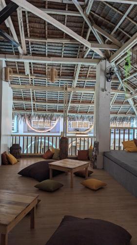 a large room with a table and pillows on the floor at Happiness Hostel Boracay in Boracay