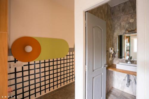 a bathroom with a sink and a mirror at Zostel Goa (Anjuna) in Anjuna