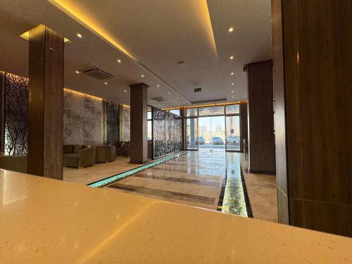 a lobby with a pool in the middle of a building at Royal Plaza Hotel in Duqm