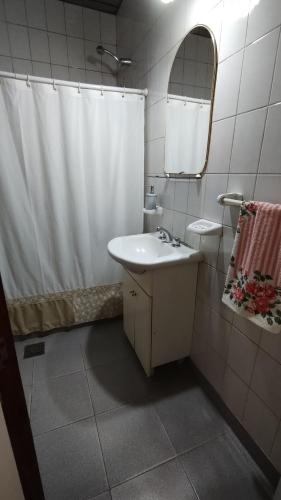 baño con lavabo y cortina de ducha en Lo de Silvia en Gualeguaychú