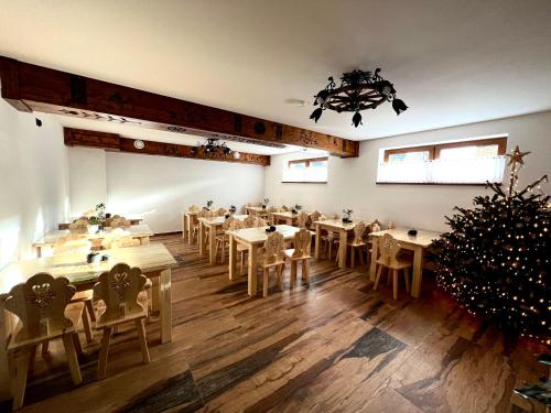 a dining room with tables and a christmas tree at Rozeta in Witów