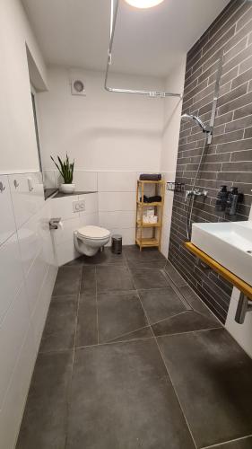 a bathroom with a toilet and a sink at Stilvoll, Zentral, Einzigartig I Küche I Parkplatz in Paderborn