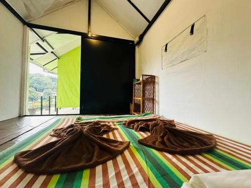 a room with two large brown blankets on the floor at The Sky Tents in Kandy