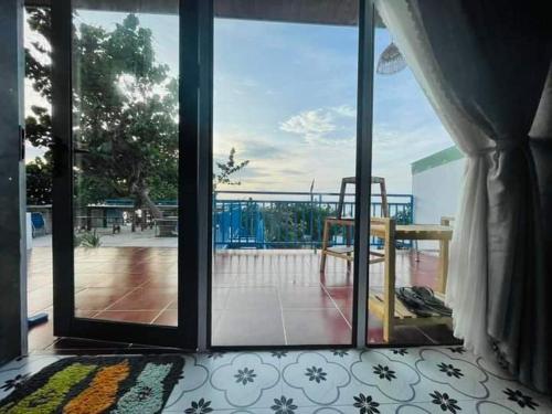 an open glass door with a view of a patio at Má Năm Homestay in Phương Phi