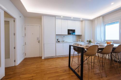 a kitchen and dining room with a table and chairs at The Zentral Suites & Apartments in Seville